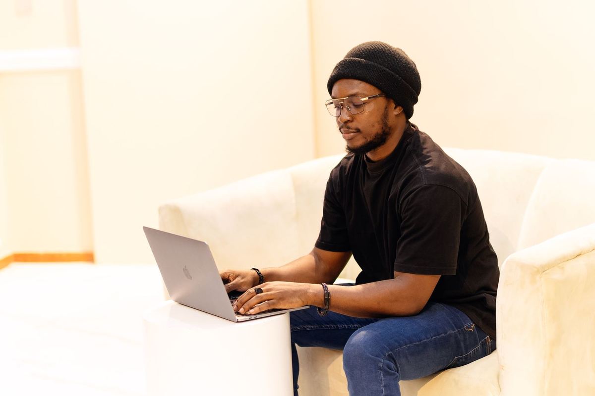 A business owner in Lagos working at a laptop.